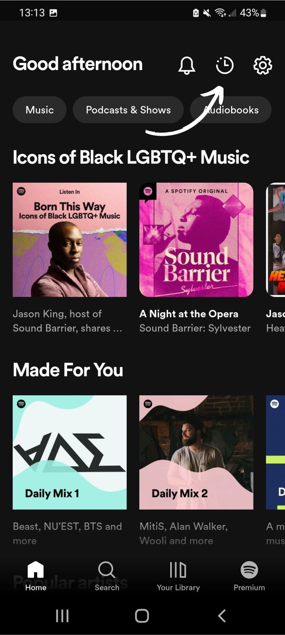Screenshot of the Spotify app on Android displaying a ‘Good afternoon’ message. An arrow is pointing at the clock button on the top right corner of the screen.