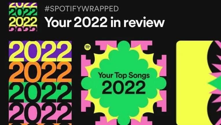 Screenshot of the Spotify Wrapped main banner featuring a hashtag reading ‘#SpotifyWrapped’, a headline saying ‘Your 2022 in Review’, and colorful graphics.
