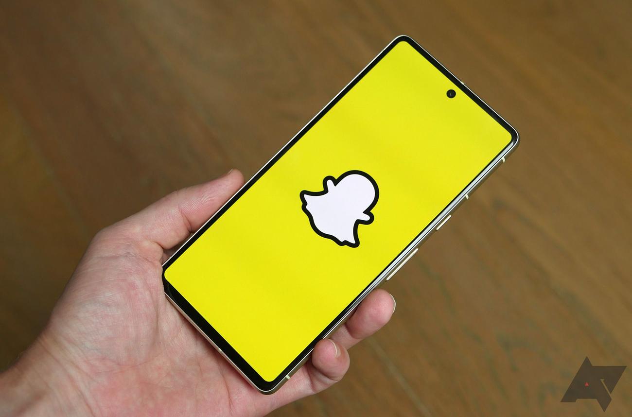 Hand holding a smartphone with Snapchat app