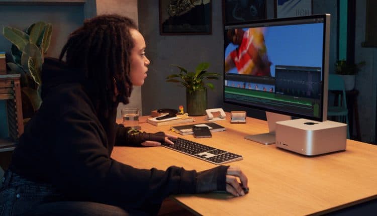 A woman using Apple Mac Studio