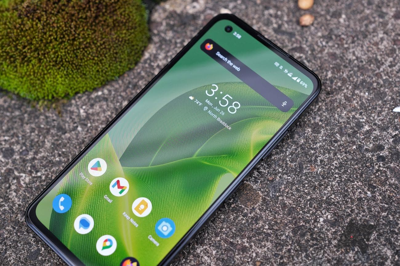 Asus Zenfone 10 resting on back with screen facing camera at angle