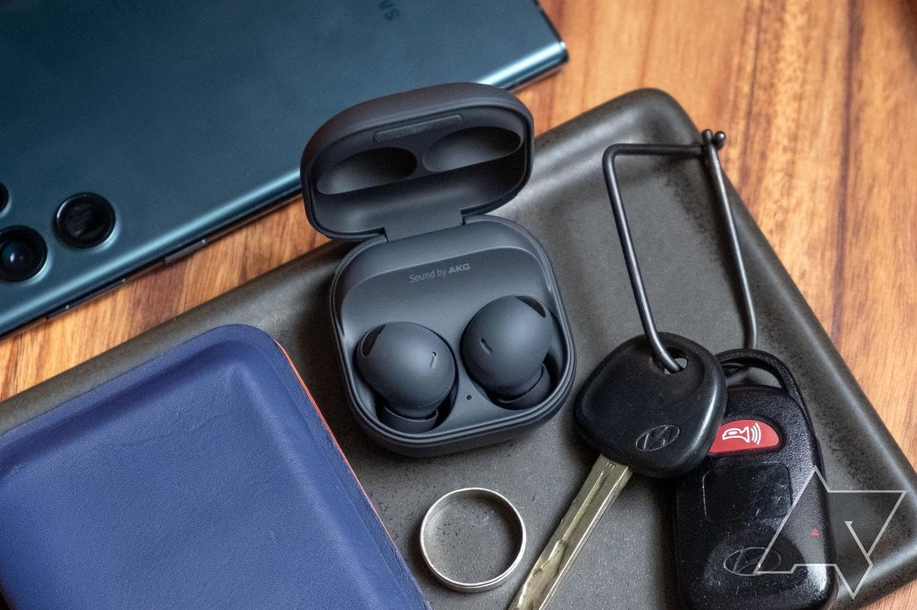 Samsung Galaxy Buds 2 Pro in a tray with some keys, a ring, and a phone