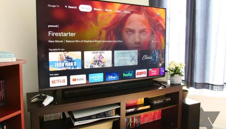 A TCL 6 series TV sitting on an entertainment center