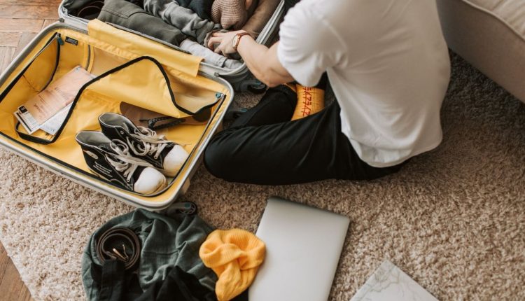 person packing a suitcase