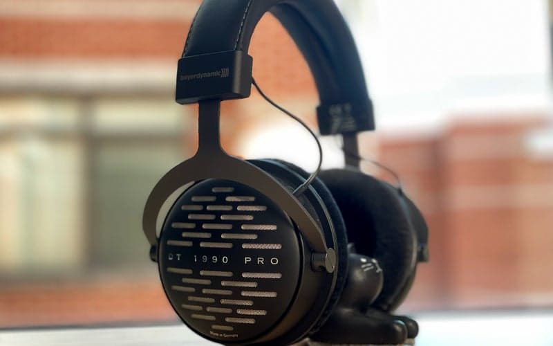 A pair of beyerdynamic 1990 Pro headphones on a window