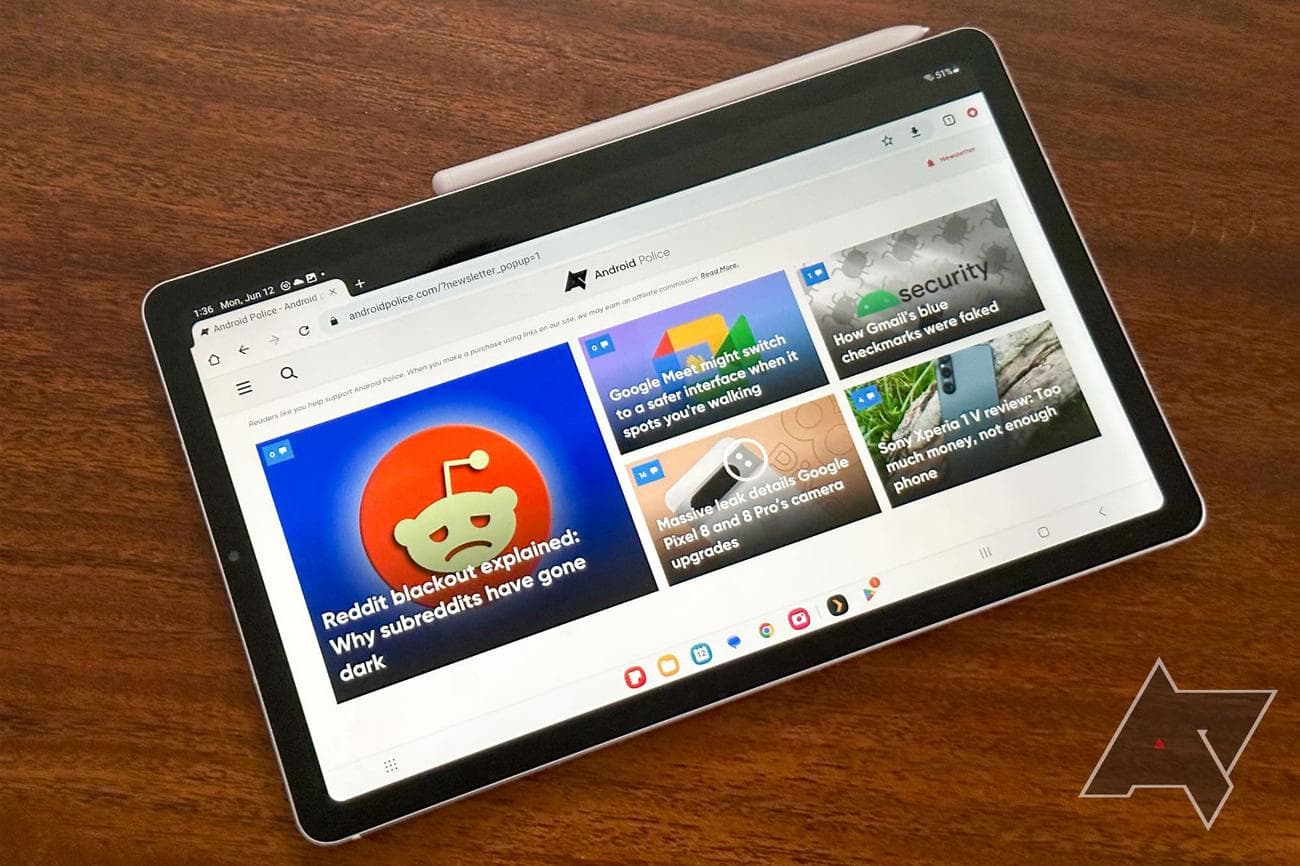 Samsung Galaxy Tab S6 Lite laying on desk with Chrome showing Android Police home page and S Pen docked on side.