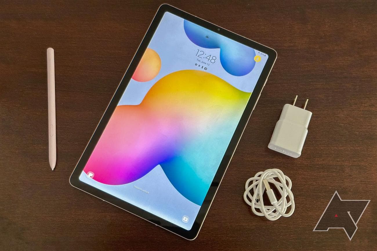 Samsung Galaxy Tab S6 Lite on table with S Pen, charger, and charging cable.