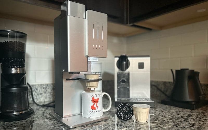 The xBloom automatic pour-over system with xPods sitting on a counter with OXO grinder, Nespresso machine, and Fellow kettle