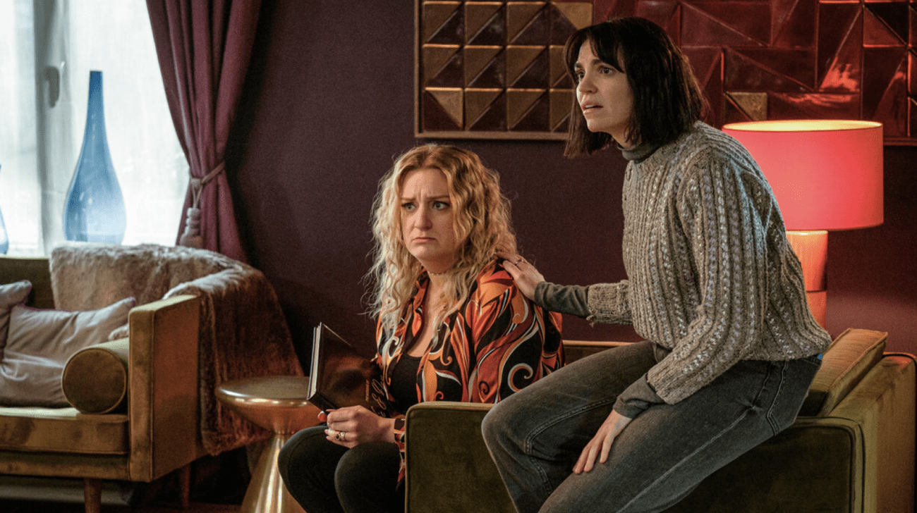 Two women sit next to each other, looking confused in "Am I Being Unreasonable?"