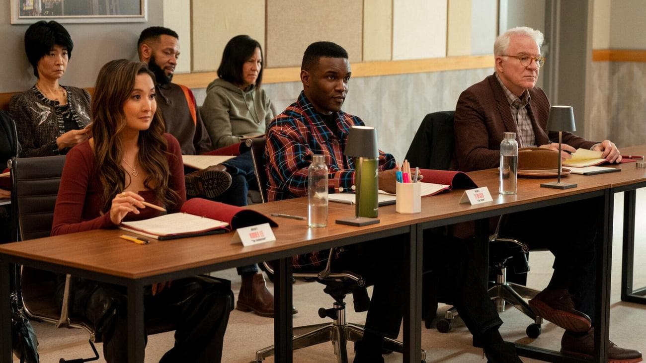 A cast sits at a table read. 