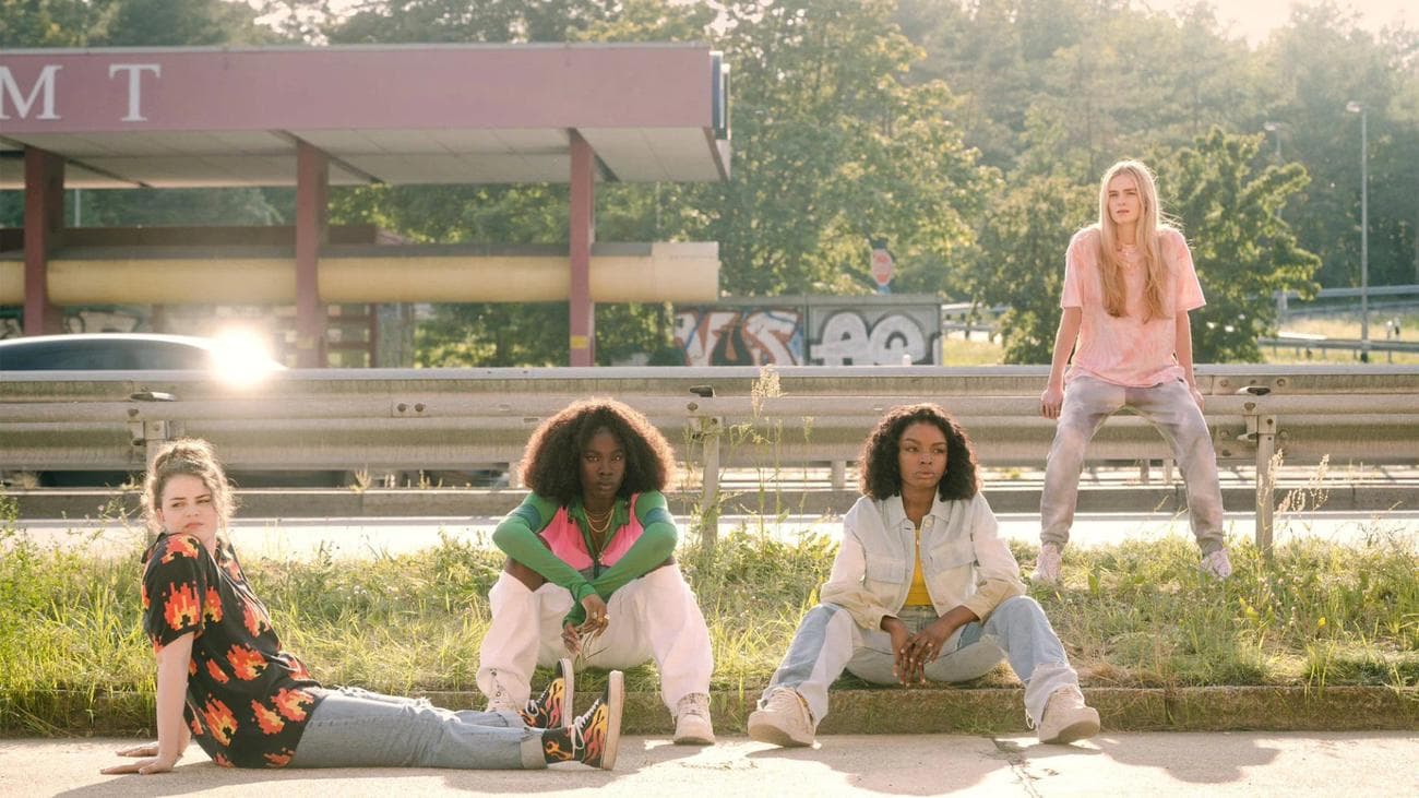Four teens sit beside a road in the show "Then You Run"