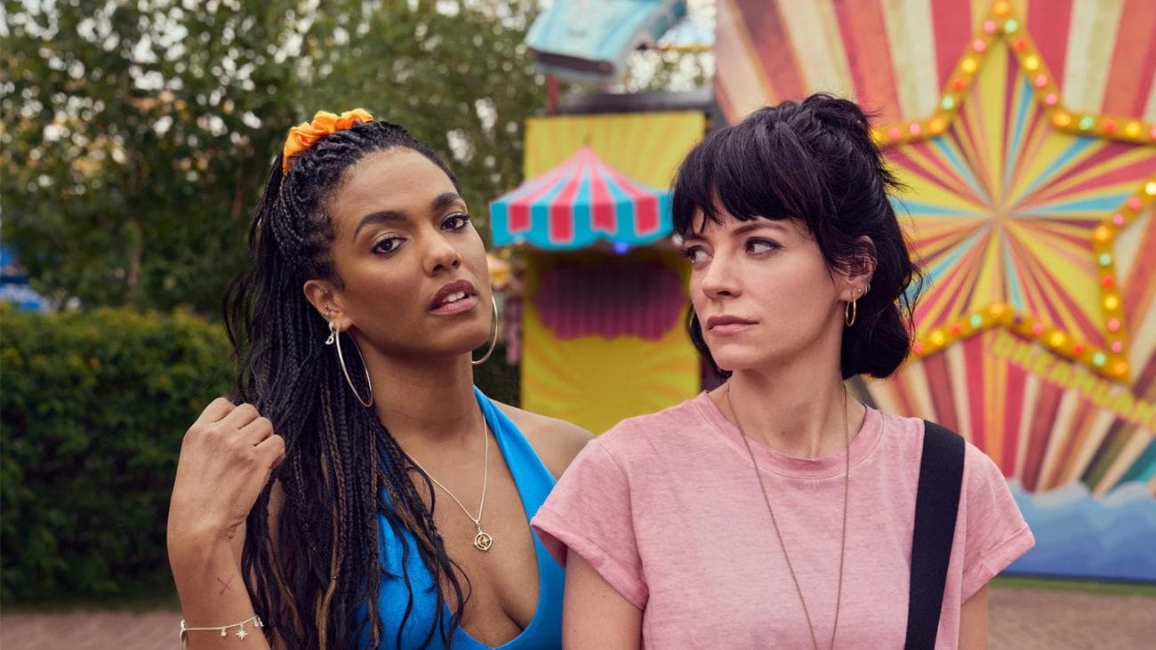 Freema Agyeman and Lily Allen pose in a carnival for the show "Dreamland"