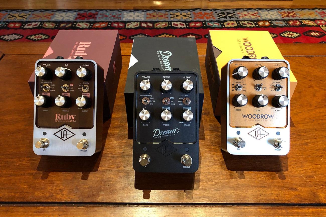 Universal Audio guitar pedals side-by-side in front of their boxes