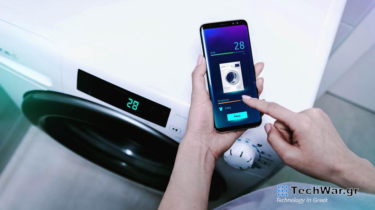Someone using a smart washing machine via their smartphone