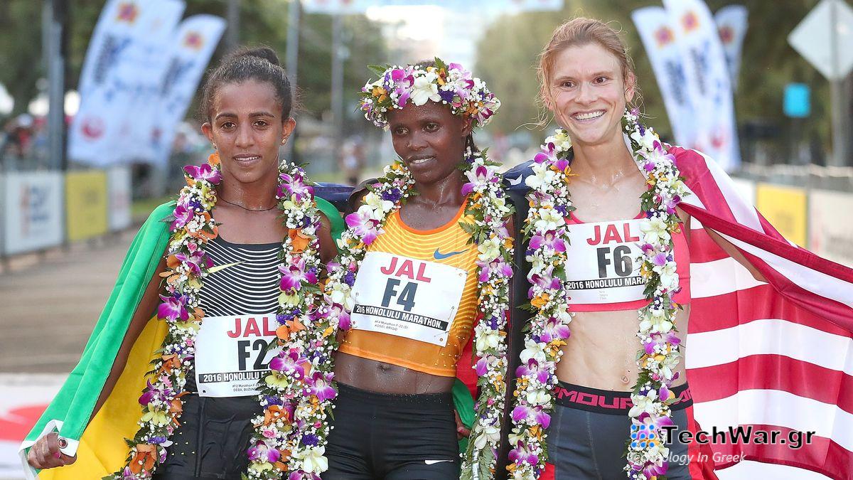 from L) Buzunesh Deba of Ethiopia, Bridgid Kosei of Kenya, and Lindsey Scherf of USA pose for photographs after winning the Honolulu Marathon