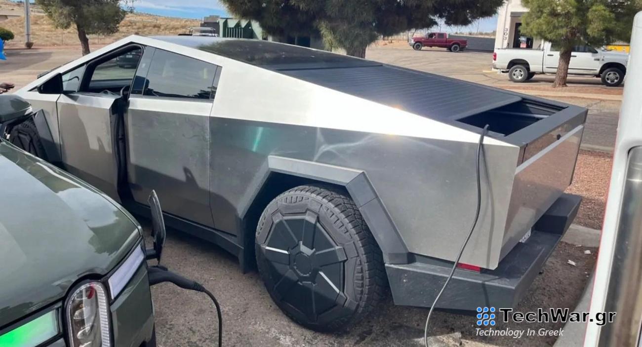 Tesla Cybertruck charging a Rivian