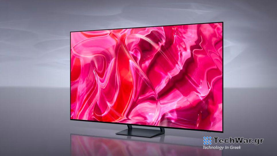 Samsung S90C in front of gray background displaying pink demonstration image