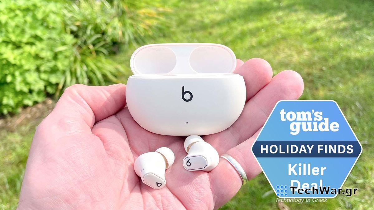 Beats Studio Buds shown in hand with charging case