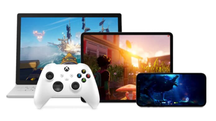 An Xbox controller next to a smartphone tablet and laptop all running different games