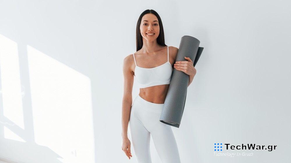 a photo of a woman holding an exercise mat