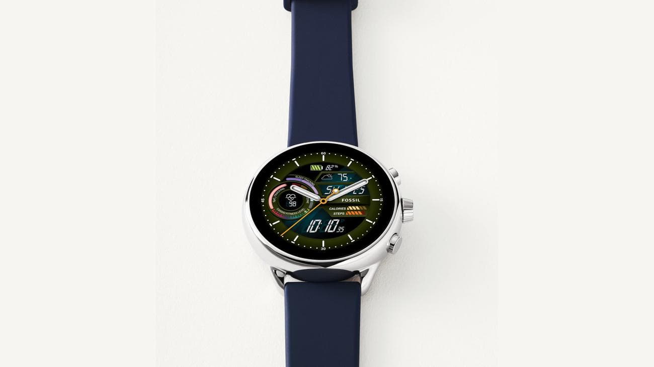 A Fossil Gen 6 Wellness Edition rests on a cream surface.