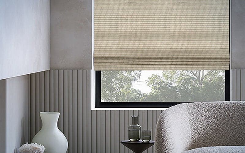 Shade Store Waterfall Woven Wood Shades behind neutral-toned furniture