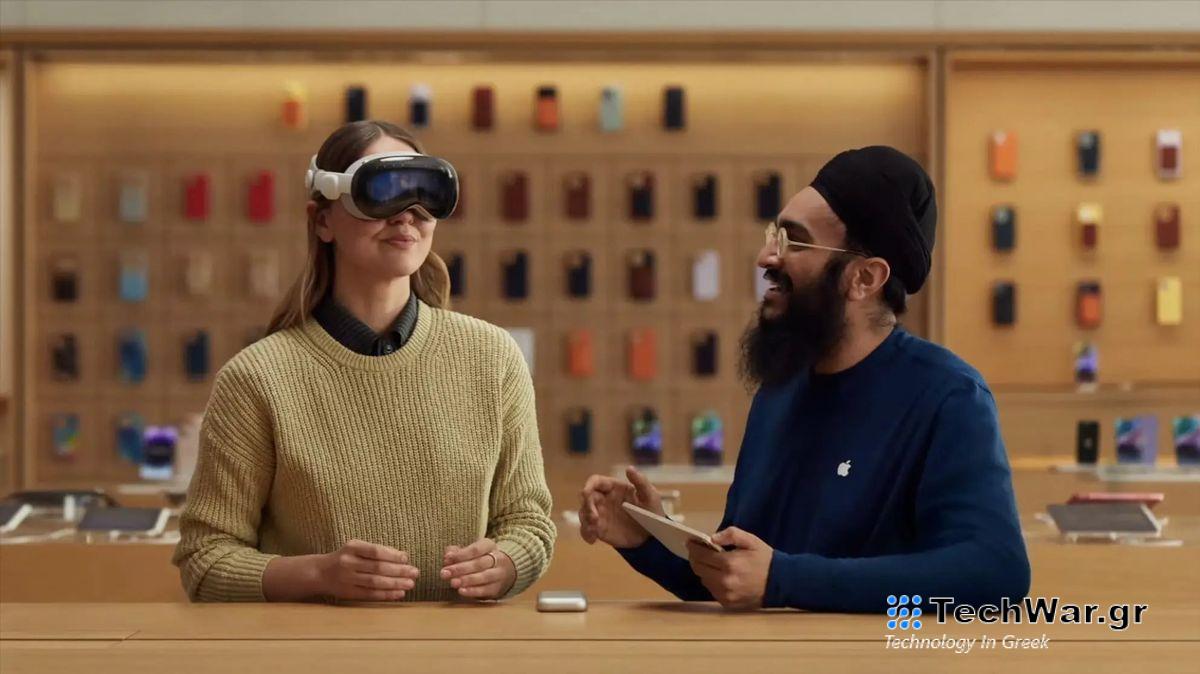 An Apple Store staff member shows a customer how to use a Vision Pro headset.