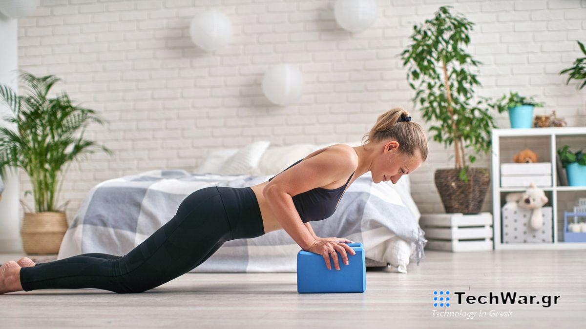 Woman performing a push-up on yoga blocks during at home workout