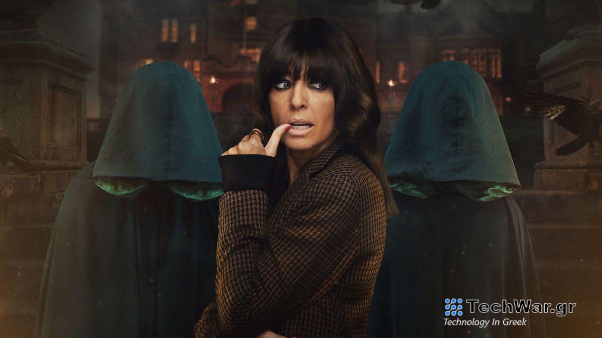 Claudia Winkleman posing in front of two hooded figures to promote The Traitors season 2