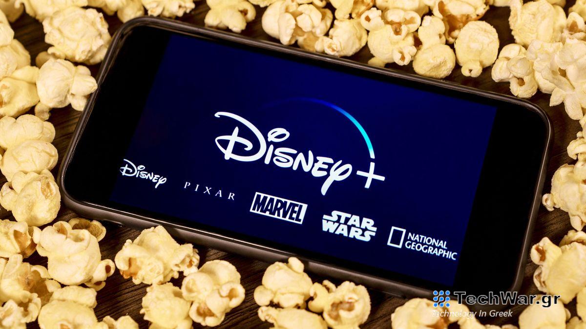 The Disney Plus logo on a phone surrounded by popcorn