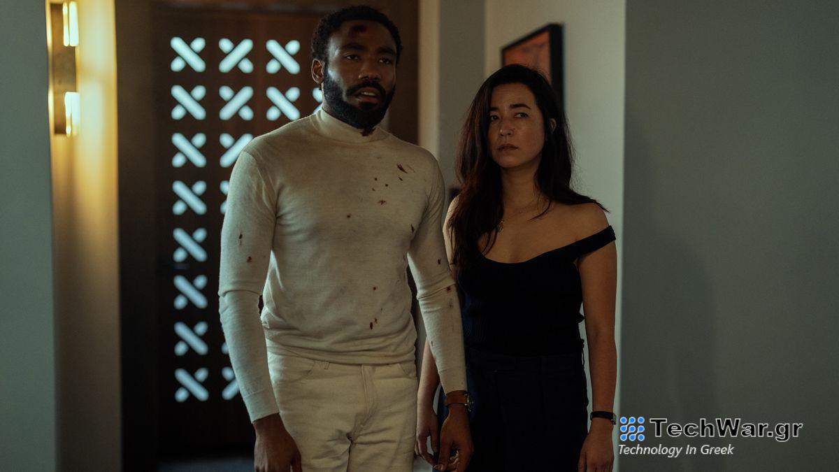 A bloodied John and Jane Smith stand in a doorway in Mr. and Mrs. Smith on Prime Video