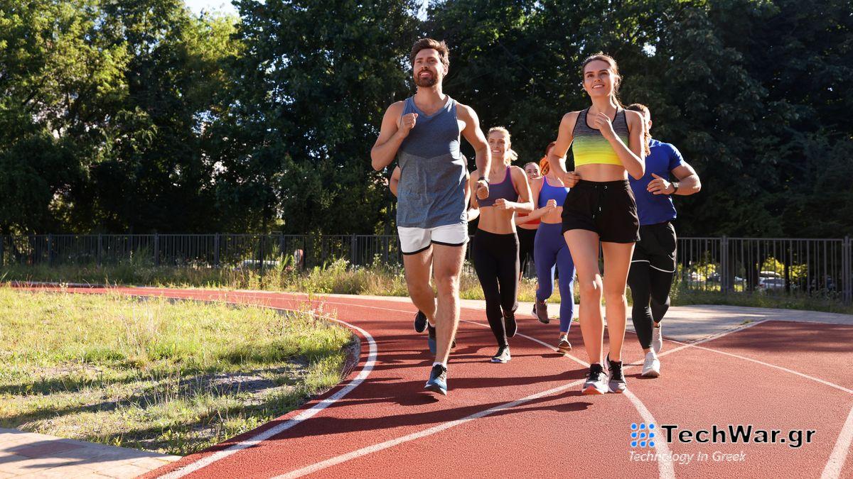 a photo of a group of people running on a red track