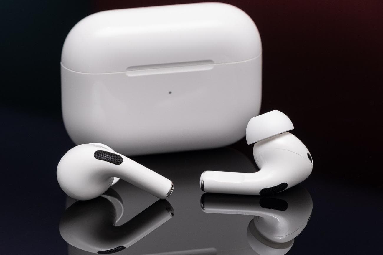 Apple's second-generation AirPods Pro photographed on a reflective black surface.