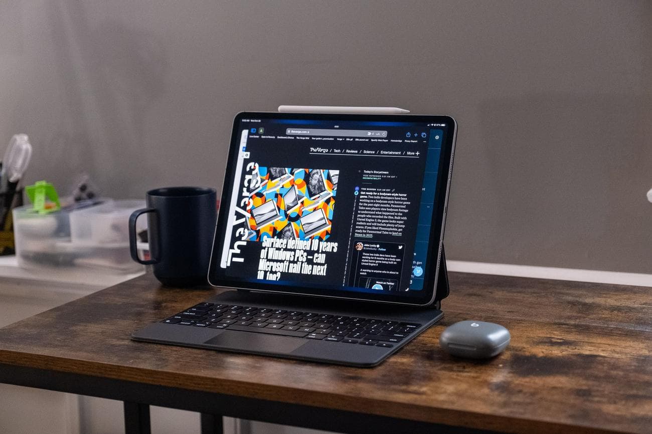 A 2022 Apple iPad Pro in a Magic Keyboard case on a wooden desk.