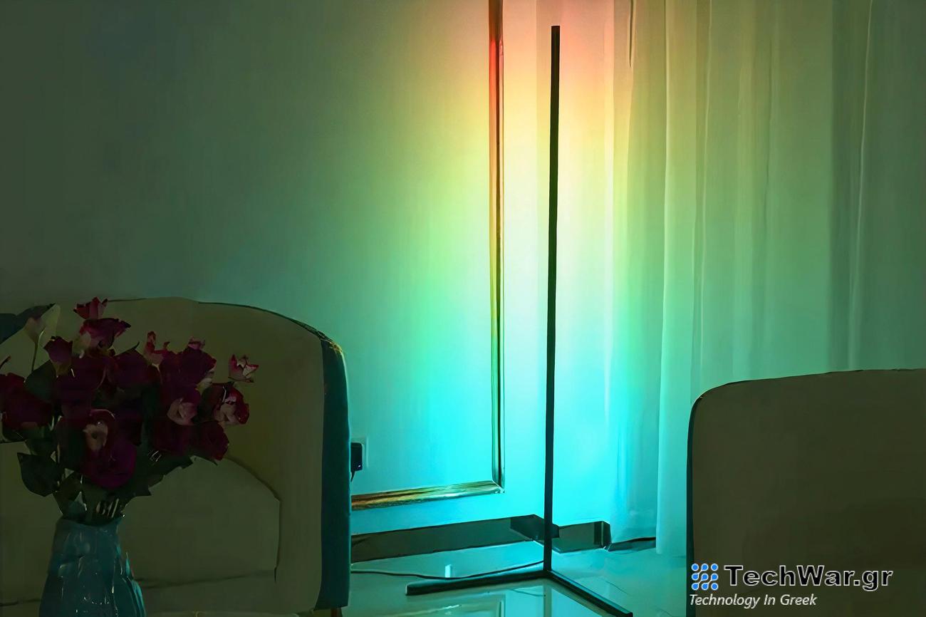 A LED corner lamp shines a rainbow-colored light on a blank wall