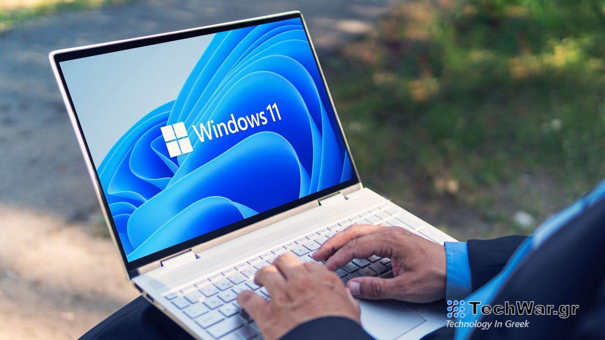 Man typing on Windows 11 laptop 