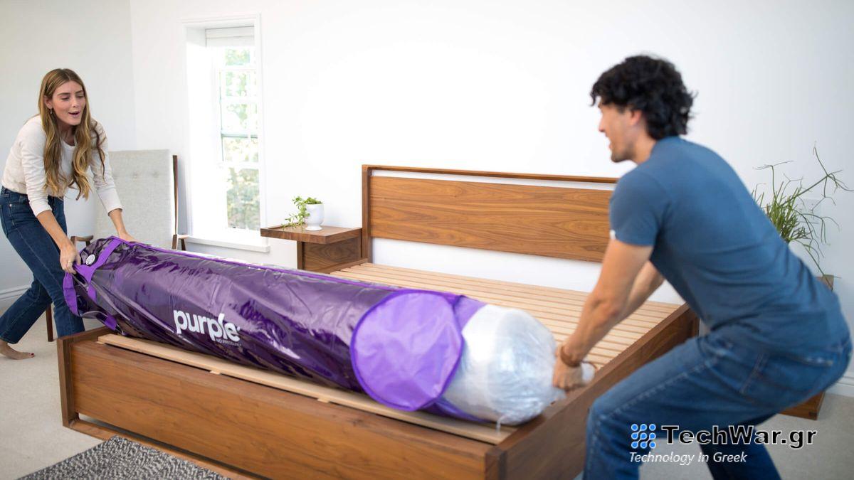 Two people removing a Purple mattress from its packaging