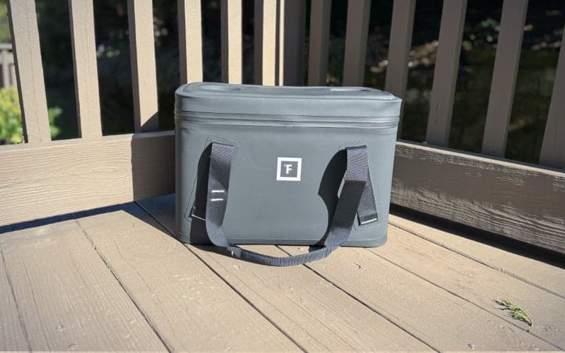 Iron Flask Soft Cooler Bag on a wooden deck.