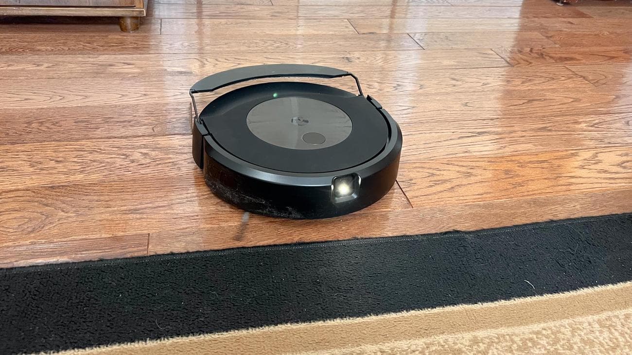 Roomba J9+ Combo robot vacuum and mop releases the onboard water tank and dust bin combined into a compact crescent shape.