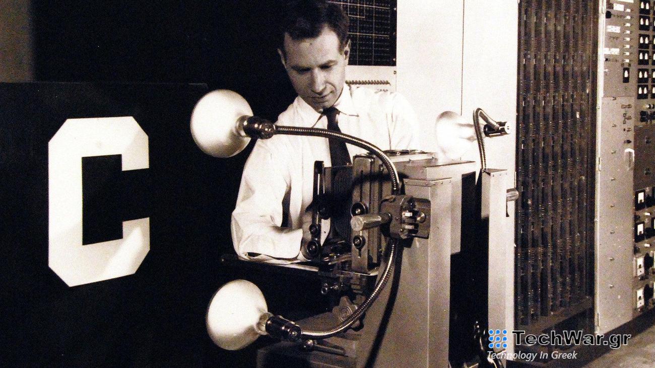 vintage photo of scientists with a robot prototype