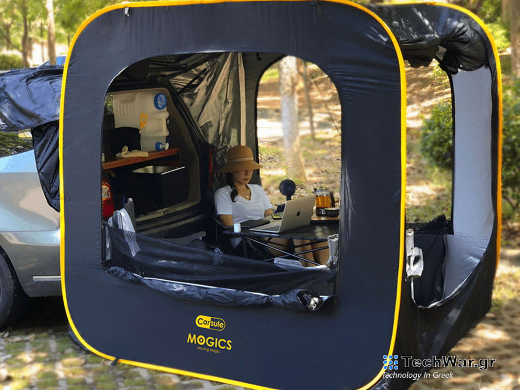 A person sitting in a pop-up tent on a plain background.