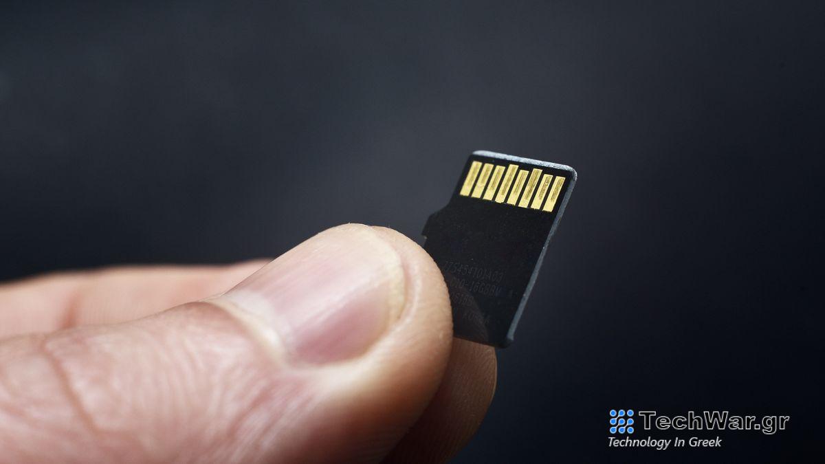 Somebody holding a microSD card with their thumb and forefinger