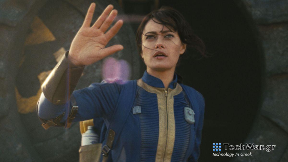 Lucy emerges from Vault 33 with her right hand raised in Amazon