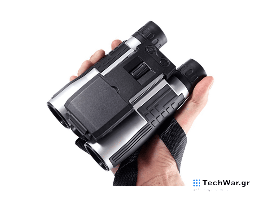 A person holding a pair of binoculars on a plain background.