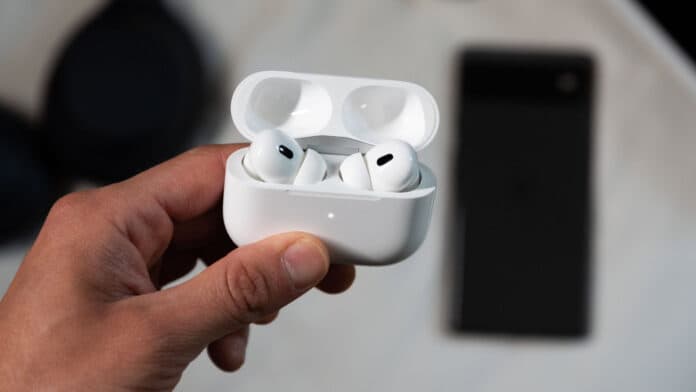 A hand holds the AirPods Pro 2nd generation while in pairing mode in front of a Pixel 6 phone.