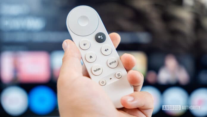 Chromecast with Google TV remote on hand stock photo (2)