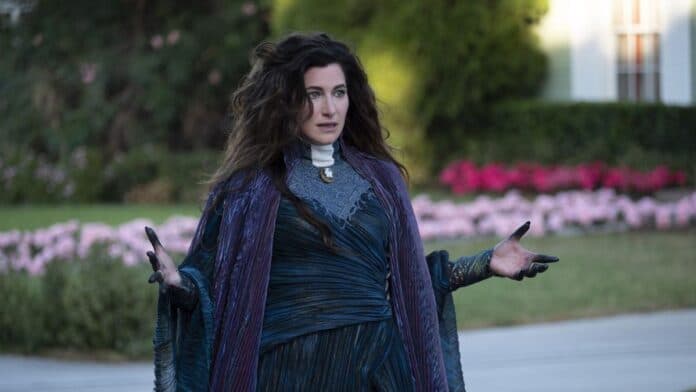 Agatha Harkness looks confused with arms outstretched in WandaVision, the prequel to Agatha All Along