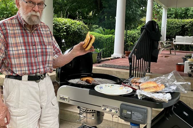  The managing editor's father posing with food fresh off his new Weber Performer Deluxe charcoal grill