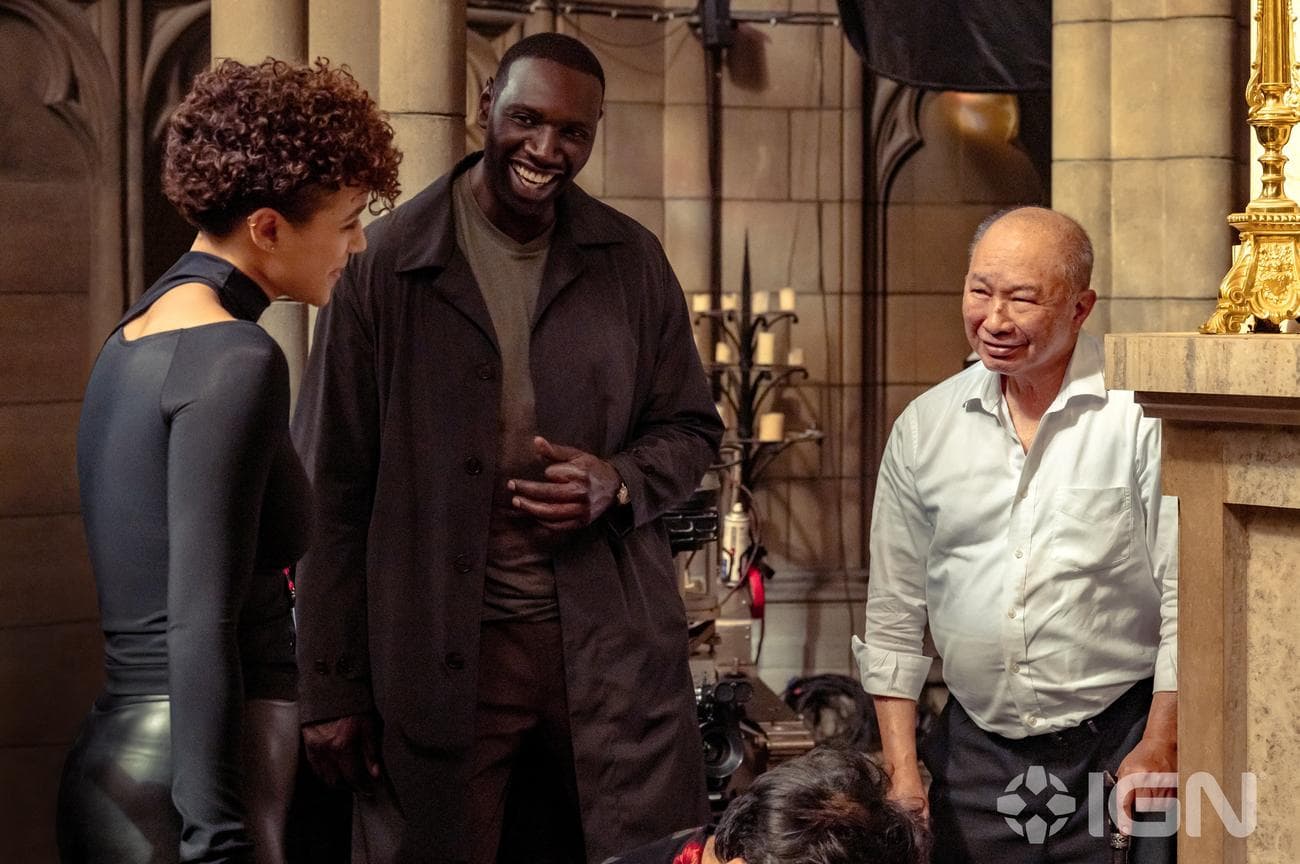 Nathalie Emmanuel, Omar Sy, and director John Woo on the set of The Killer.