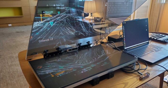 An image of a prototype projector that reflects glasses-free 3D onto a car’s windshield.